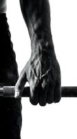 Muscular male hand gripping a barbell with chalk dust, dramatic black and white close-up showcasing strength and determination in weightlifting.