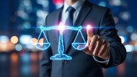 Professional businessman touching glowing digital scales of justice hologram representing legal technology and law firm services at night.