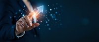 Businessman hand touching glowing upward arrow with digital particles and light effects on dark blue background, representing growth, success, and financial progress.
