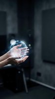 Hands holding glowing digital globe with light effects against dark urban background, representing global connectivity, technology innovation, and worldwide business communication.