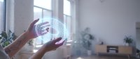 Hands holding futuristic holographic globe with data visualization in modern office space for technology and innovation concepts.