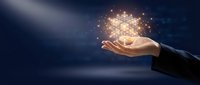 Open hand holding glowing digital data particles and light effects against dark blue background, representing technology innovation, data management, and business solutions.