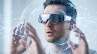 Young Caucasian man wearing futuristic VR headset interacting with holographic interface elements in digital technology environment for innovation concepts.