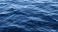 Deep blue ocean waves creating natural ripple patterns on water surface in sunlight, abstract marine background for environmental and nature designs.