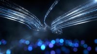 Digital data streams flowing in curved light trails with blue bokeh effects on dark background for technology and connectivity concepts.