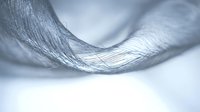 Abstract flowing silver metallic fabric waves creating elegant curves and ripples with soft lighting and smooth texture for luxury design backgrounds.
