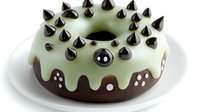 Chocolate donut with mint glaze and black spikes decoration on white plate, creative punk rock pastry design for modern bakery and confectionery.