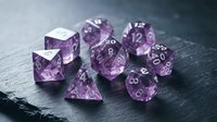 Polished amethyst gemstone dice set with silver numbers for tabletop gaming, role-playing games, and fantasy adventures on dark slate surface.