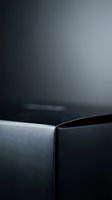 Modern dark gray metallic surface with smooth curved edge and gradient lighting for luxury product photography backgrounds.