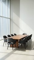 Modern conference room with wooden table and black chairs in bright office space with natural sunlight streaming through large windows.