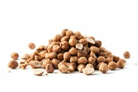 Fresh roasted hazelnuts scattered in pile on white background, some cracked showing light interior. Isolated nuts for food photography and packaging design.