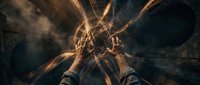 Person standing at center of dramatic light beams radiating outward creating mystical energy portal effect with golden rays and atmospheric smoke.