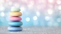Colorful pastel zen stones stacked in balance against soft blue bokeh background with glitter sparkle effect, creating serene spa and wellness atmosphere.