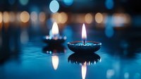 Glowing oil lamp floating on water with blue bokeh background, creating peaceful ambiance for spiritual ceremonies.