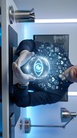 Businessman in dark suit and white gloves holding glowing digital shield with cybersecurity icons and network symbols, representing data protection and secure technology solutions.