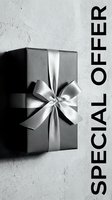 Dark gift box with silver satin ribbon bow on gray concrete background, special offer text, luxury holiday sale promotion banner.