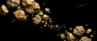 Golden nuggets and precious metal fragments scattered on dark surface for mining industry and wealth investment concepts.