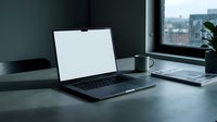 Modern laptop computer with blank white screen on dark office desk near window for business presentations and remote work productivity.