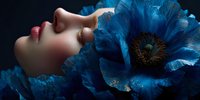 Young woman with closed eyes and red lips surrounded by large blue fantasy flowers on dark background for beauty and skincare concepts.