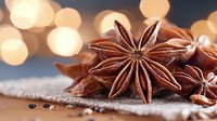Star anise pods on rustic linen fabric with soft golden bokeh lights in background, aromatic spice macro photography for culinary and seasonal designs.