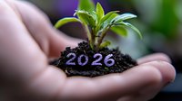 Young green sprout growing from soil in cupped hands with number 2026, symbolizing future growth, environmental sustainability and long-term planning.