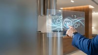 Modern businessman touching transparent digital interface with FAQ hologram in contemporary office environment for customer service solutions.