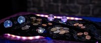 Professional poker table with chips and cards under dramatic neon lighting for casino gaming entertainment and gambling concepts.