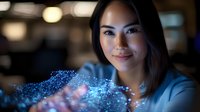 Young Asian businesswoman in blue blazer interacting with glowing digital particles and holographic elements, representing future technology and innovation.