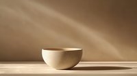 Empty ceramic bowl on wooden surface with dramatic diagonal light rays creating minimalist composition in warm sepia tones, modern zen aesthetic.