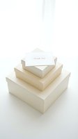 Three stacked cream gift boxes with a thank you card on top, elegant minimal style for wedding, holiday, or luxury packaging concepts.