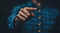 Male hand pointing at digital checklist with golden checkmarks on transparent interface, concept of task completion and productivity management.