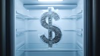 Frozen dollar sign made of ice in empty refrigerator with blue light illumination, symbolizing cold cash, frozen assets and financial concepts.