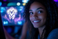 Young African American woman with curly hair smiling in neon lights environment, glowing heart shape bokeh in background creates romantic nightlife atmosphere.