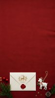 Festive holiday flat lay with cream envelope sealed with red wax, gold reindeer motif, white ceramic goat ornament, evergreen sprigs, red baubles, and gold stars on deep red textured background for seasonal greeting cards and Christmas marketing.