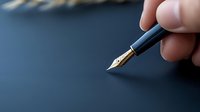 Hand holding elegant fountain pen with gold nib on dark blue surface ready for writing, business correspondence or creative work.