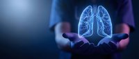 Medical professional holding glowing lung anatomy hologram for healthcare technology and respiratory system education in modern clinical setting.
