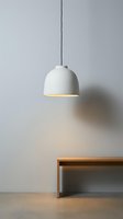 Modern white dome pendant lamp hanging above wooden bench in minimalist interior space, suitable for home decor, lighting design, and contemporary architecture projects.