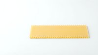 Uncooked lasagna pasta sheet with ridged edges isolated on white background, ready for cooking and culinary design projects.