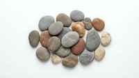 Collection of smooth river rocks and pebbles in natural earth tones isolated on white background for spa, meditation, and wellness design projects.