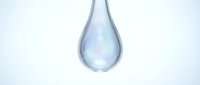 Clear water drop with iridescent rainbow reflections falling against clean white background for purity and freshness concepts in health and wellness designs.