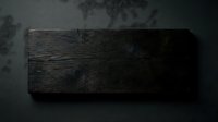 Dark rustic wooden board on a dark background with natural grain texture, knots, and aged surface, perfect for food photography and product display.