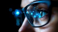 Close-up view of eyeglasses reflecting blue digital lights and sparkles against dark background, capturing modern technology interaction and screen reflection.