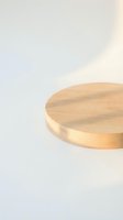 Wooden round platform or podium with natural light oak finish on neutral beige background, suitable for product display and mockup presentations.