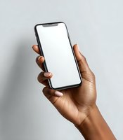 African American female hand holding modern smartphone with blank white screen against neutral gray background for app or website mockup.