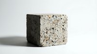 Modern terrazzo cube sample showcasing speckled stone aggregate pattern in neutral tones for contemporary interior design and architectural material selection.