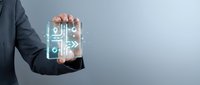 Businessman holding glowing digital circuit board with electronic pathways and connections for technology presentations and corporate innovation concepts.