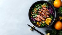 Grilled duck breast with quinoa, red cabbage, oranges and fresh herbs in black bowl on light background, asian fusion cuisine style food photography.