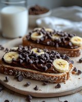 Chocolate banana toast with cocoa spread and chocolate chips on wooden board. Healthy breakfast or snack option for morning meal preparation.