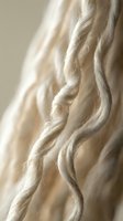 Twisted natural fiber rope with cream and beige tones, showcasing detailed texture and craftsmanship for design, textile, and material reference projects.