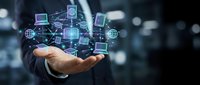 Businessman holding digital technology icons and network connections in palm of hand, representing cloud computing, data transfer, and global connectivity solutions.